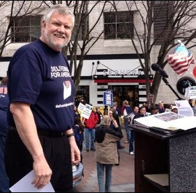 Bob James, President of the Washington Association of Letter Carriers (and WSLC Vice President), prepares to address the Seattle crowd March 24.