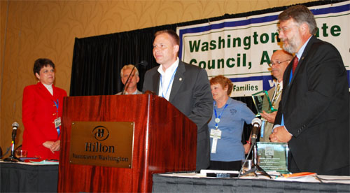 Christian Dube of Operating Engineers Local 286 accpets the Mother Jones Award on behalf of his union and the laid-off Hostess workers.