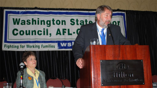 WSLC President Jeff Johnson delivers his opening remarks Thursday as WSLC Secretary-Treasurer Lynne Dodson looks on.