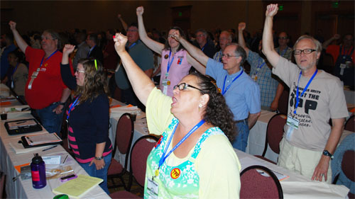 Delegates sing along.